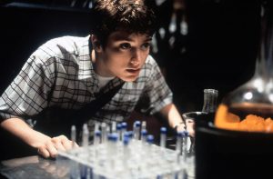 Elijah Wood leaning over vials in a scene from the film 'The Faculty', 1998. (Photo by Buena Vista/Getty Images)